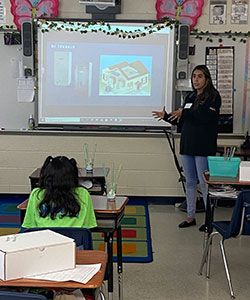 Ana teaching student in classroom