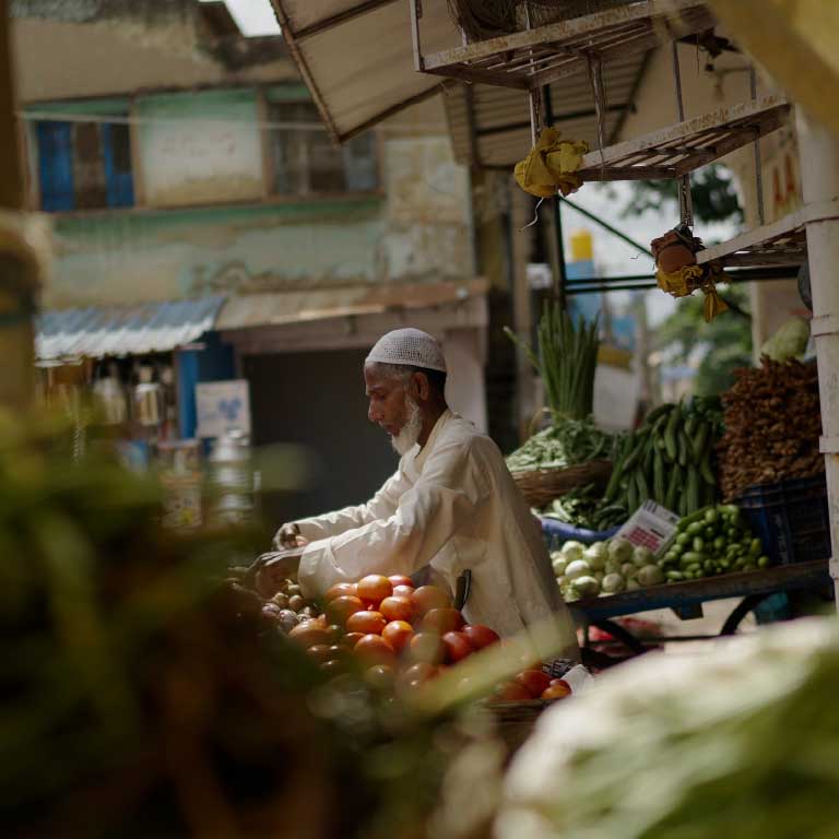 street vendor preparing his vegetable cart